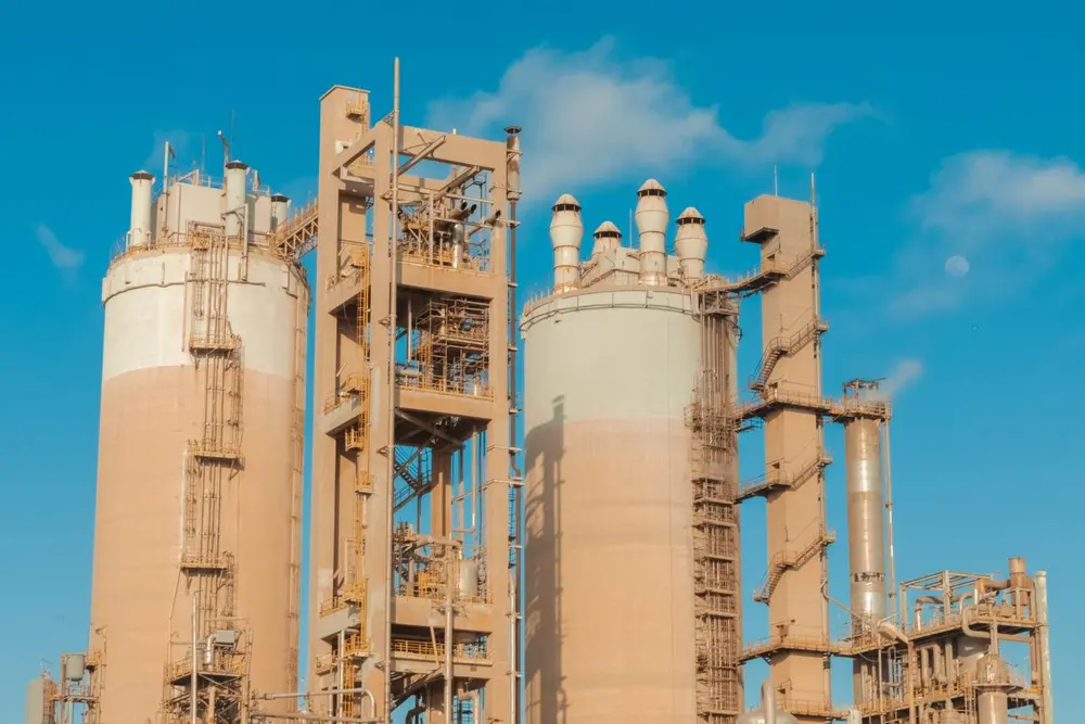 Chemical plant towers against a blue sky