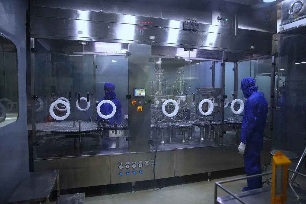 Technicians in a sterile pharmaceutical facility